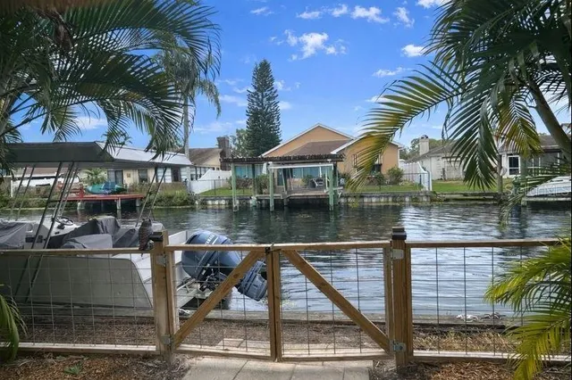 a view of a lake and a patio with swimming pool
