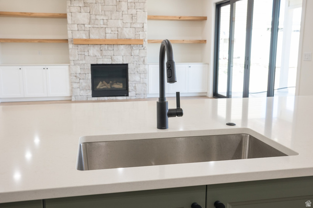 3322 250 S Street Vernal, UT 84078 - Photo 7 of 37 Kitchen island with a stainless steel sink and matte black faucet, featuring a light-colored countertop