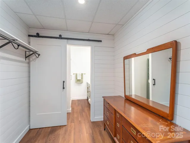 a view of a balcony with chairs and wooden floor