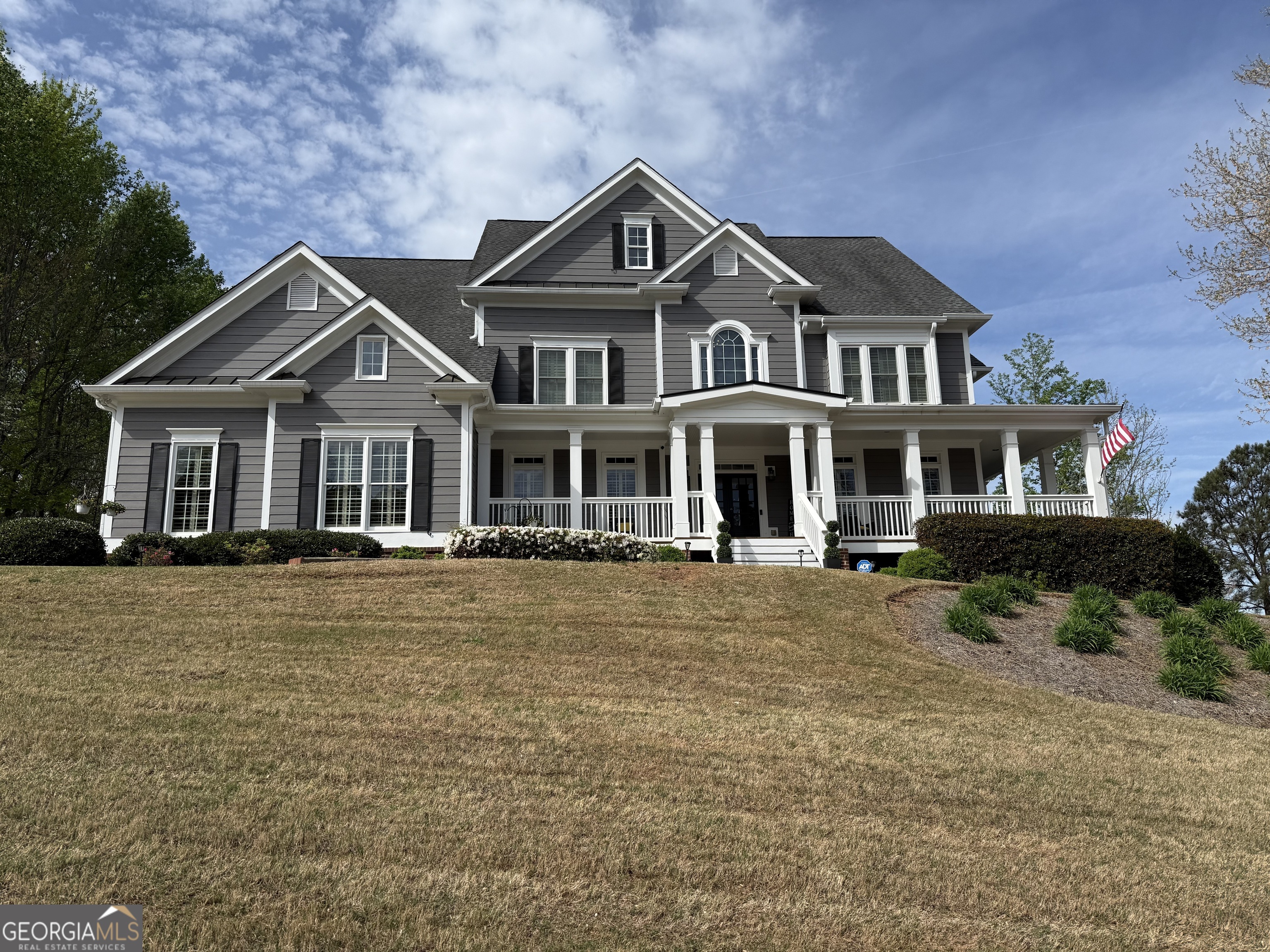 a front view of a house with a garden