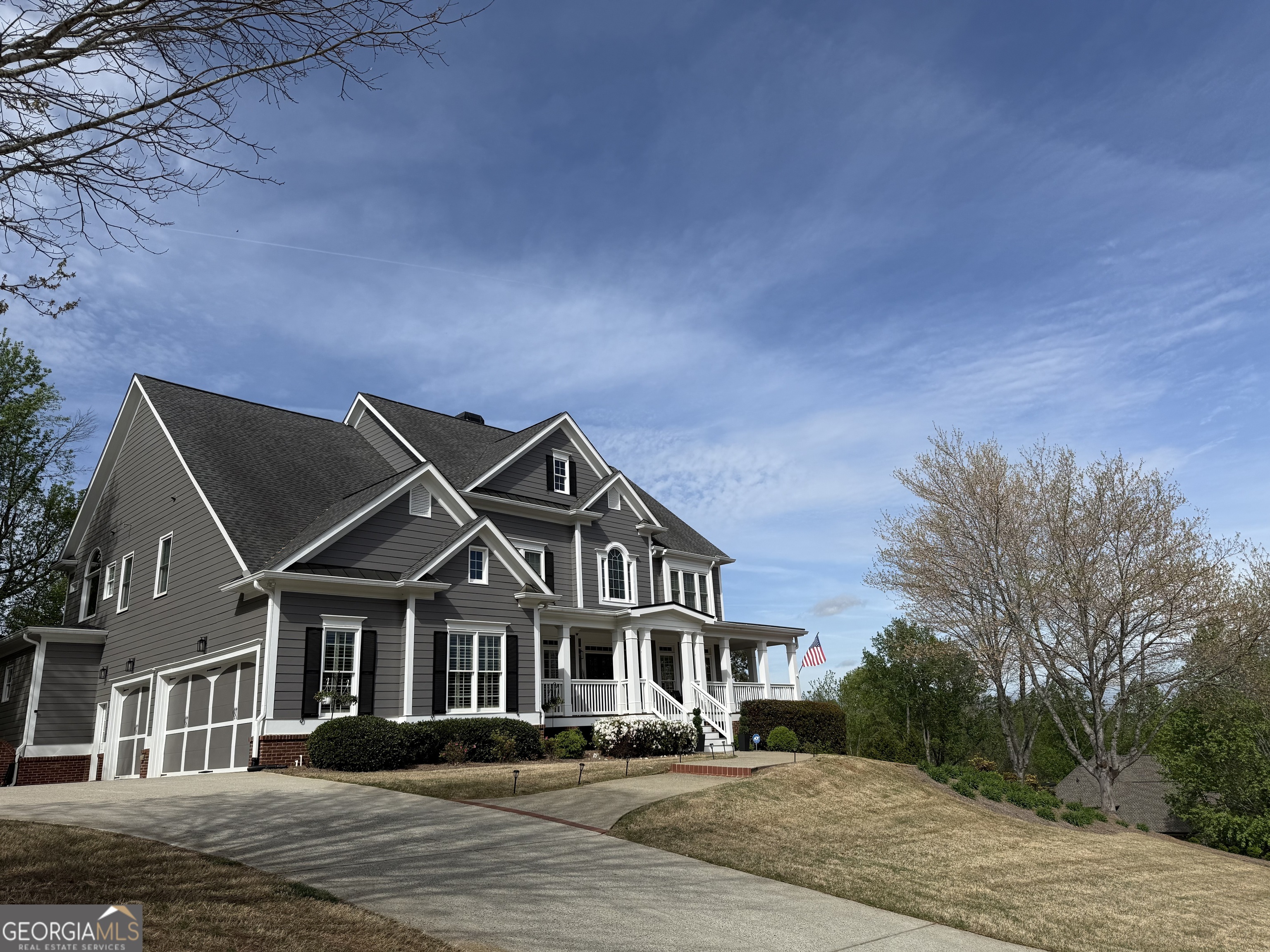 990 Chateau Forest Road Hoschton, GA 30548 - Photo 2 of 117 a front view of a house with a yard