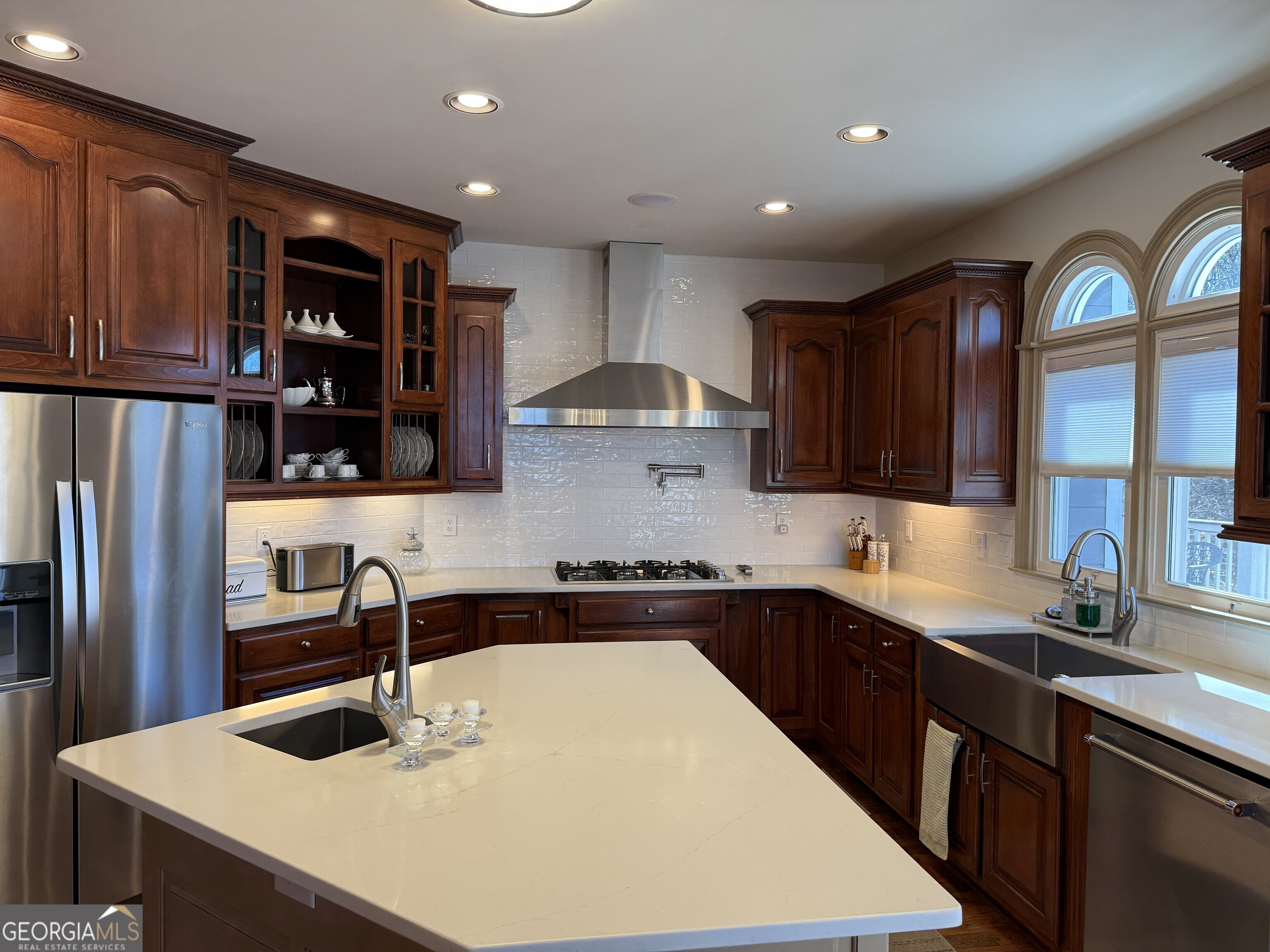 990 Chateau Forest Road Hoschton, GA 30548 - Photo 28 of 117 a kitchen with stainless steel appliances granite countertop a sink refrigerator and cabinets