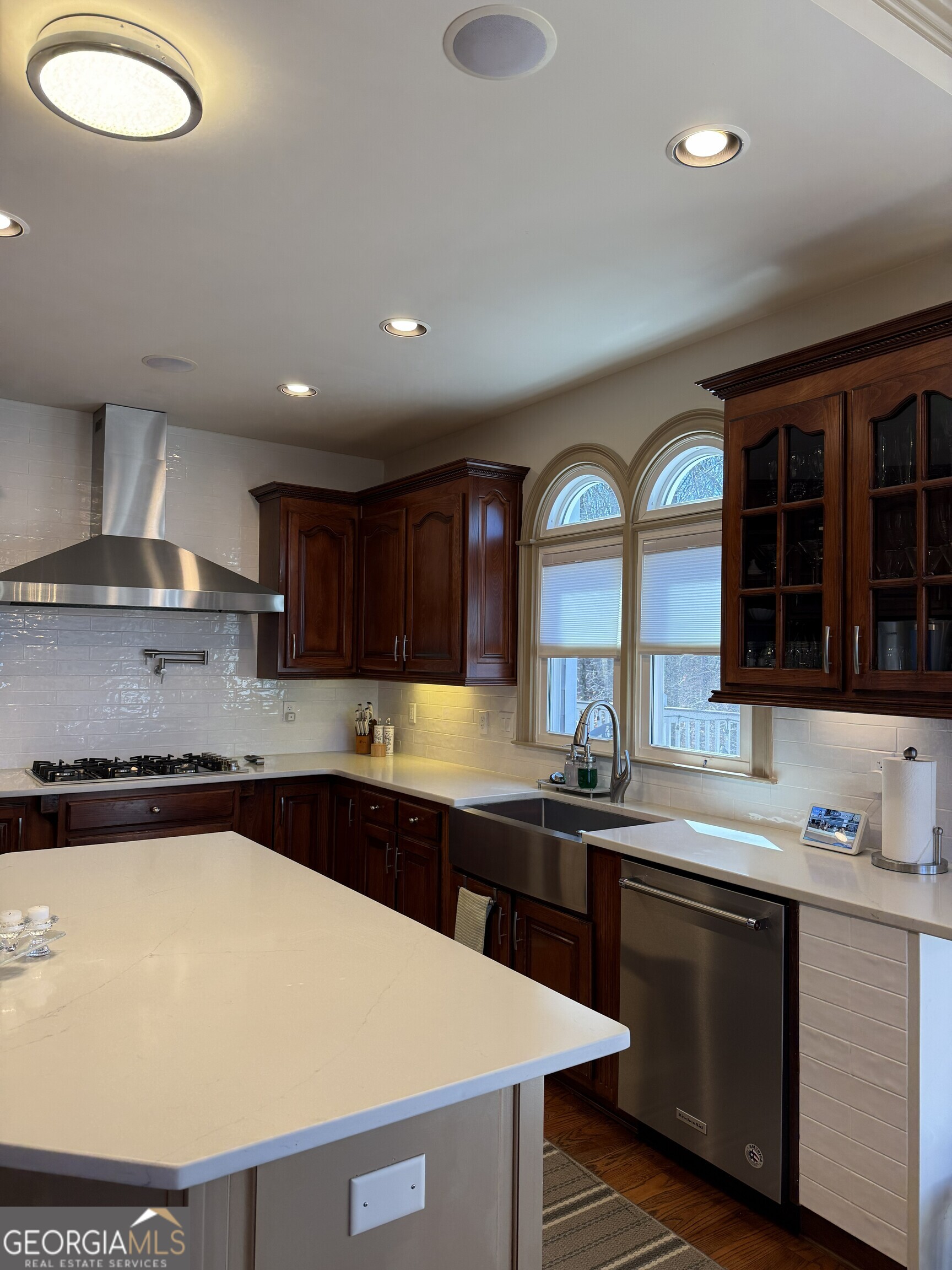 990 Chateau Forest Road Hoschton, GA 30548 - Photo 29 of 117 a kitchen with stainless steel appliances granite countertop a sink a stove and a microwave