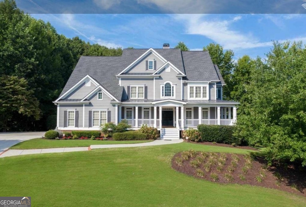 990 Chateau Forest Road Hoschton, GA 30548 - Photo 3 of 117 a front view of a house with garden