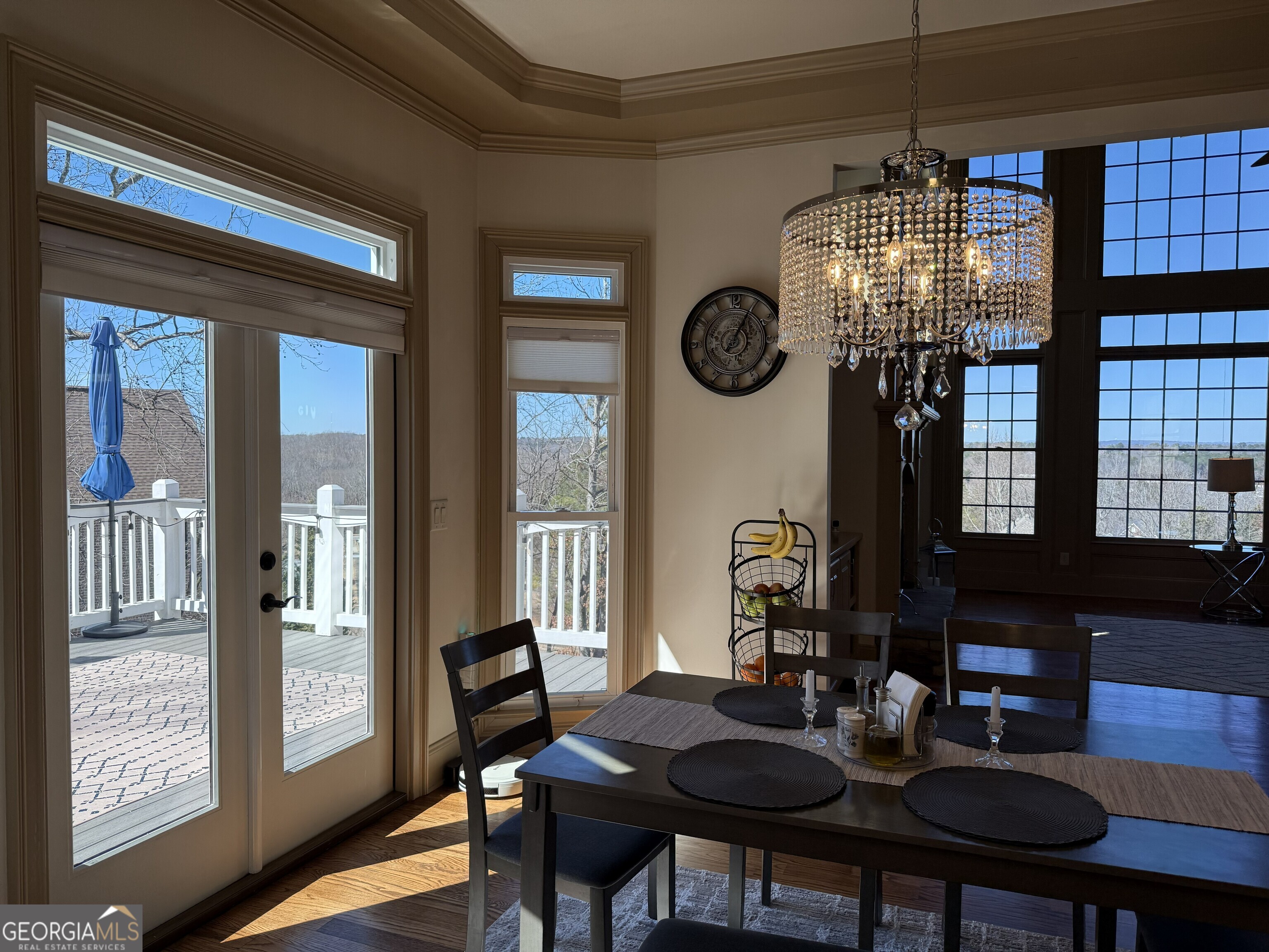 990 Chateau Forest Road Hoschton, GA 30548 - Photo 32 of 117 a view of a dining room with furniture a chandelier and wooden floor