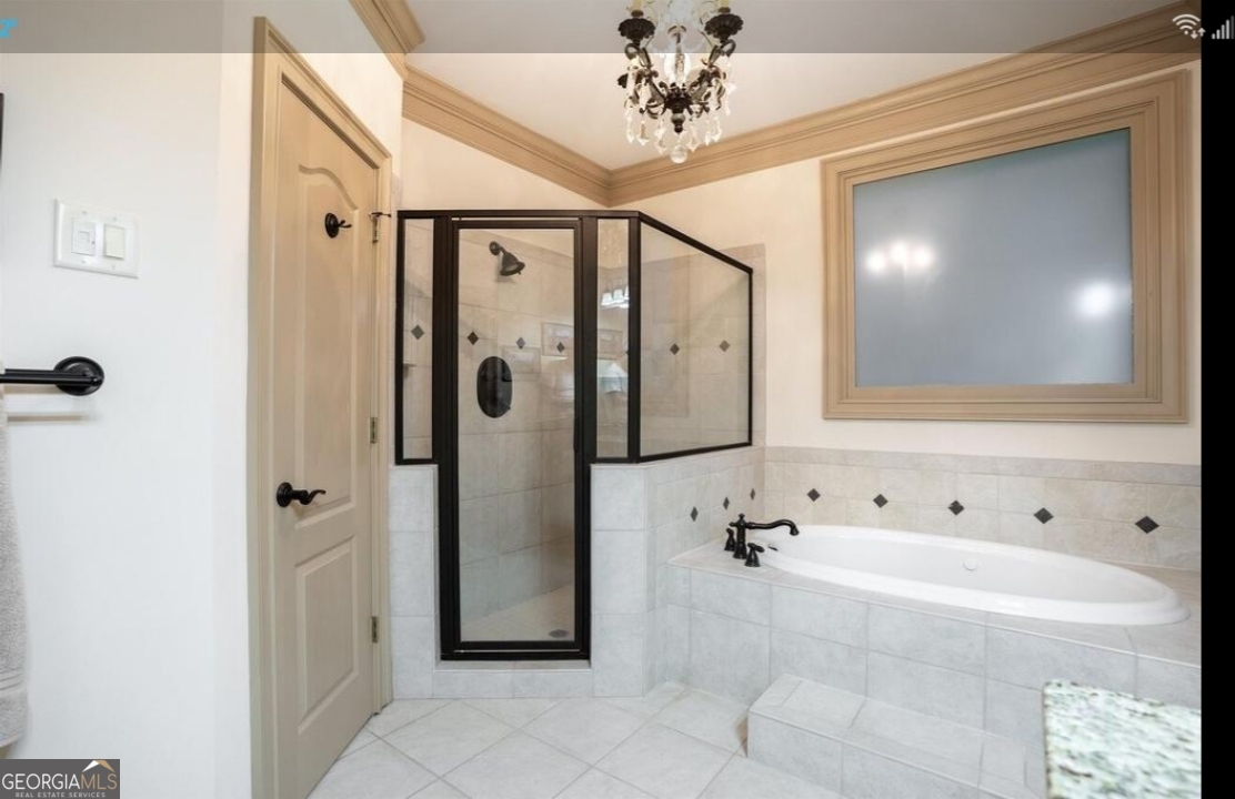 990 Chateau Forest Road Hoschton, GA 30548 - Photo 48 of 117 a bathroom with a bathtub and a shower