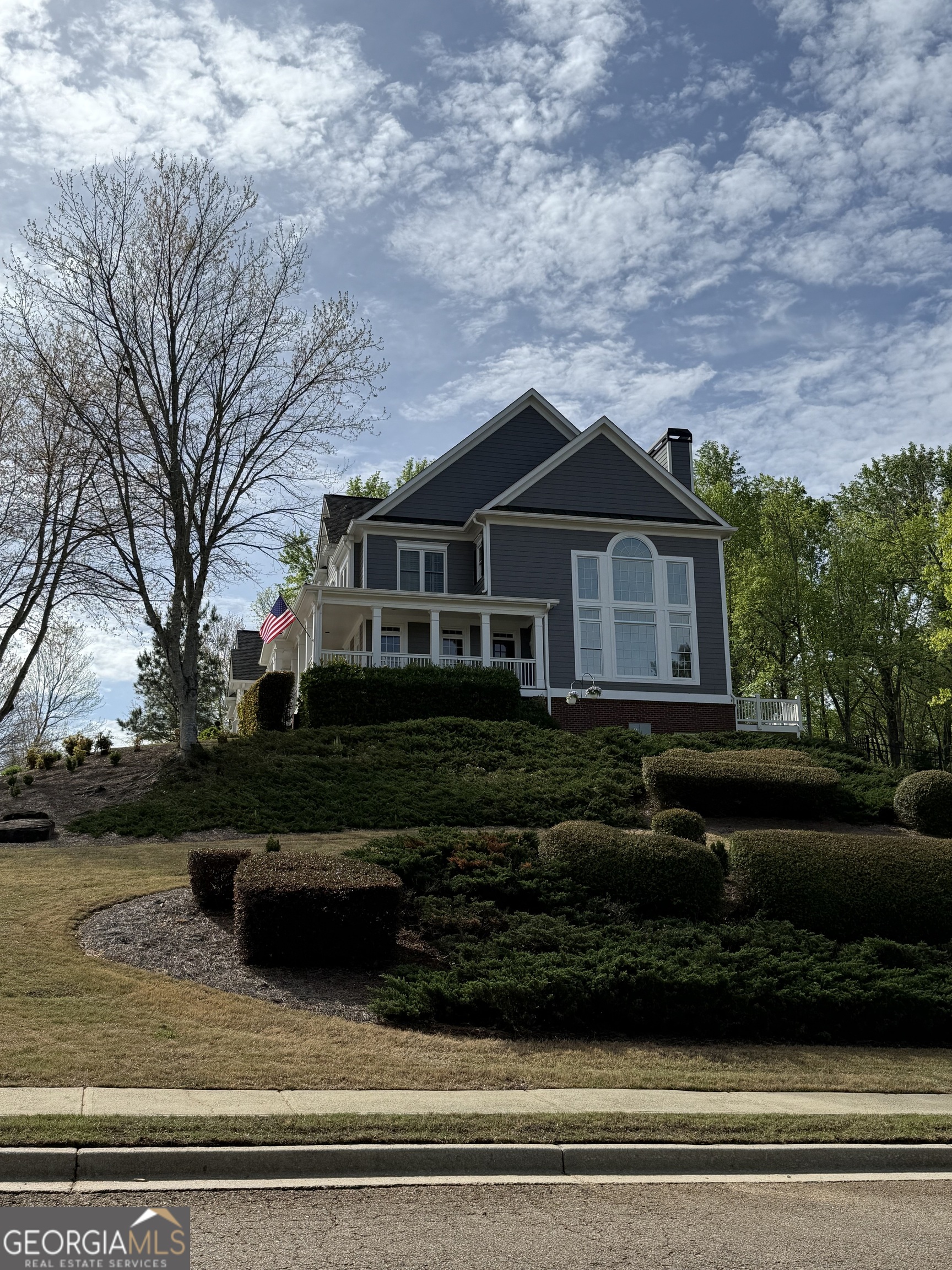 990 Chateau Forest Road Hoschton, GA 30548 - Photo 72 of 117 a front view of a house with a garden
