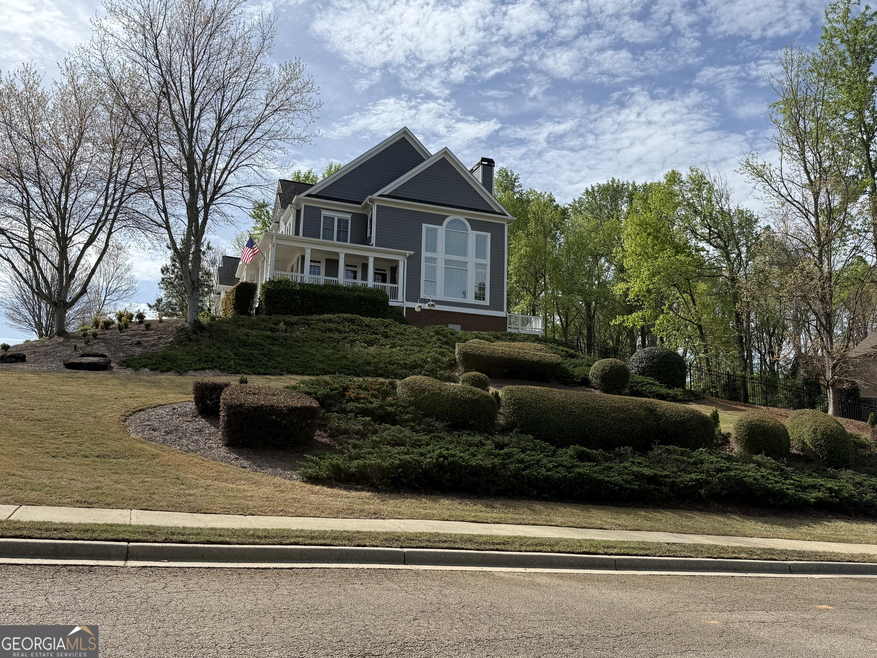 990 Chateau Forest Road Hoschton, GA 30548 - Photo 84 of 117 a front view of a house with a garden
