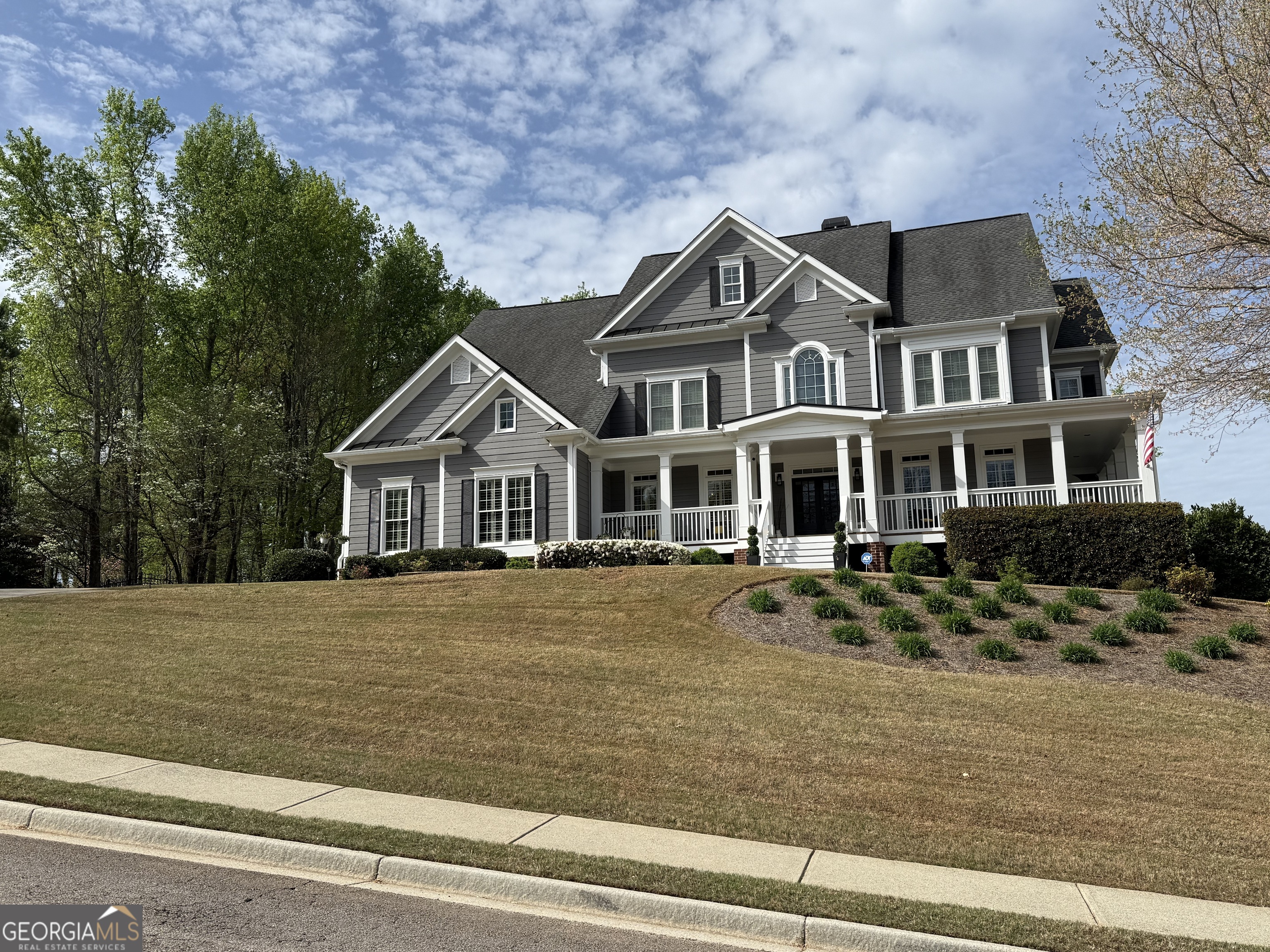 990 Chateau Forest Road Hoschton, GA 30548 - Photo 88 of 117 a front view of a house with a garden