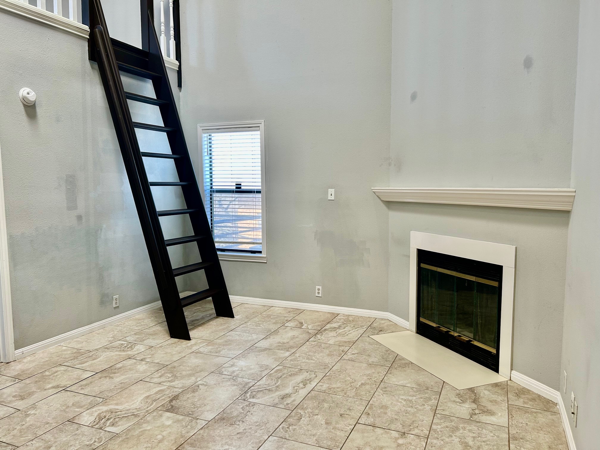 502 West 17th Street, Unit K Austin, TX 78701 - Photo 15 of 18 a bedroom with a bed and a fireplace