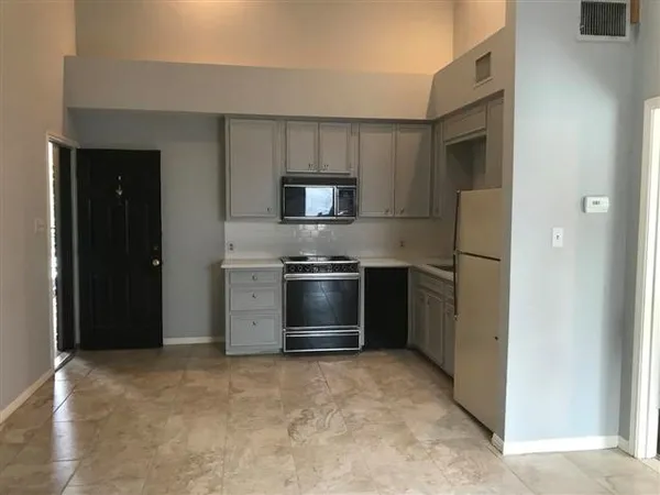 a kitchen with a refrigerator stove and a sink