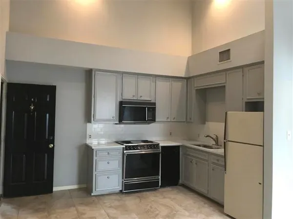 a kitchen with a refrigerator stove and microwave
