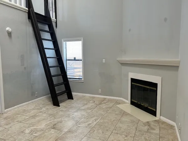 a view of a livingroom with wooden floor and fireplace