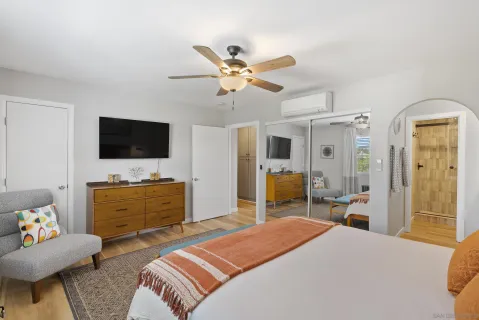 a bedroom with a bed and a flat screen tv