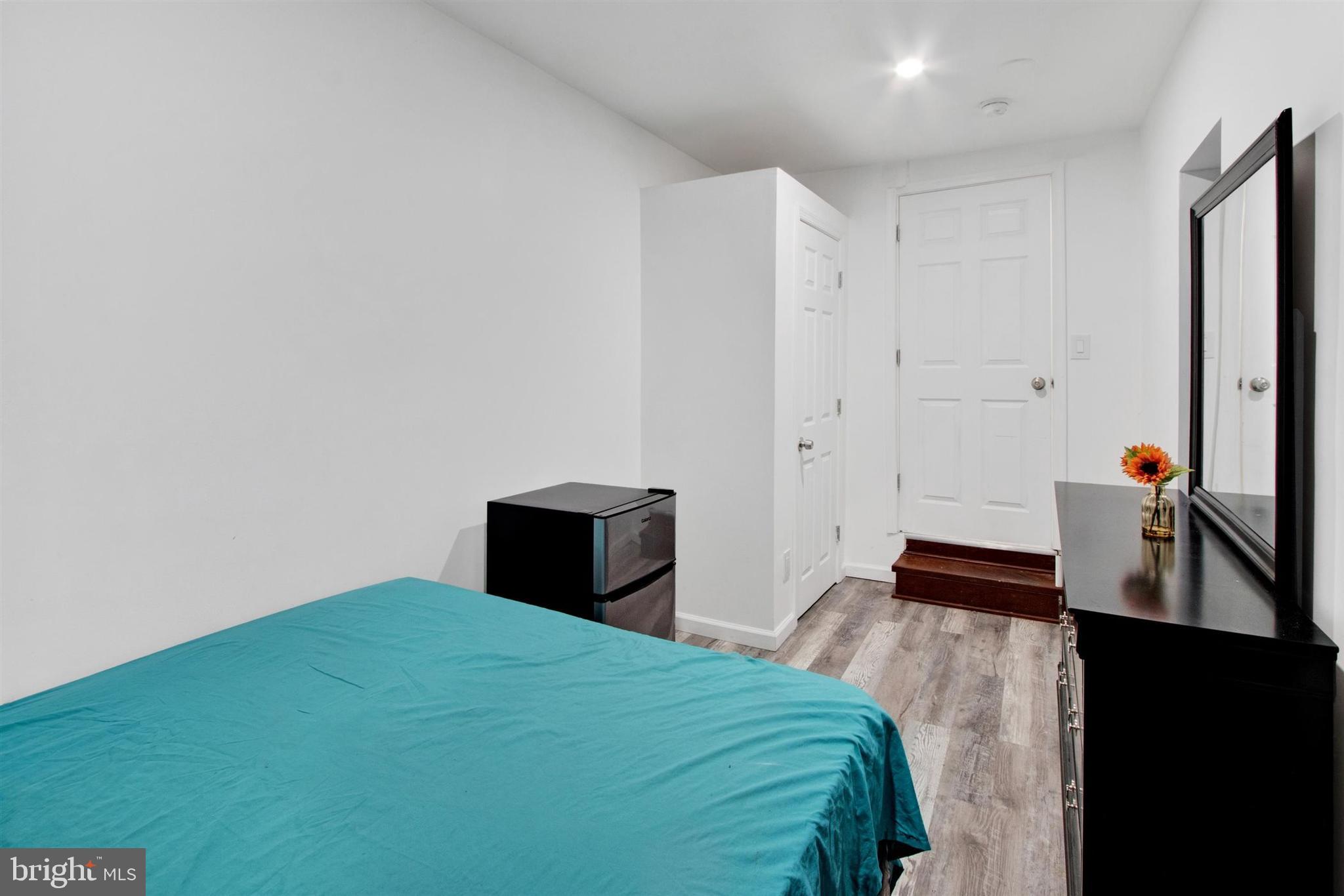 1045 Chestnut Street Reading, PA 19602 - Photo 12 of 21 a bedroom with a bed and a flat tv screen on a dresser