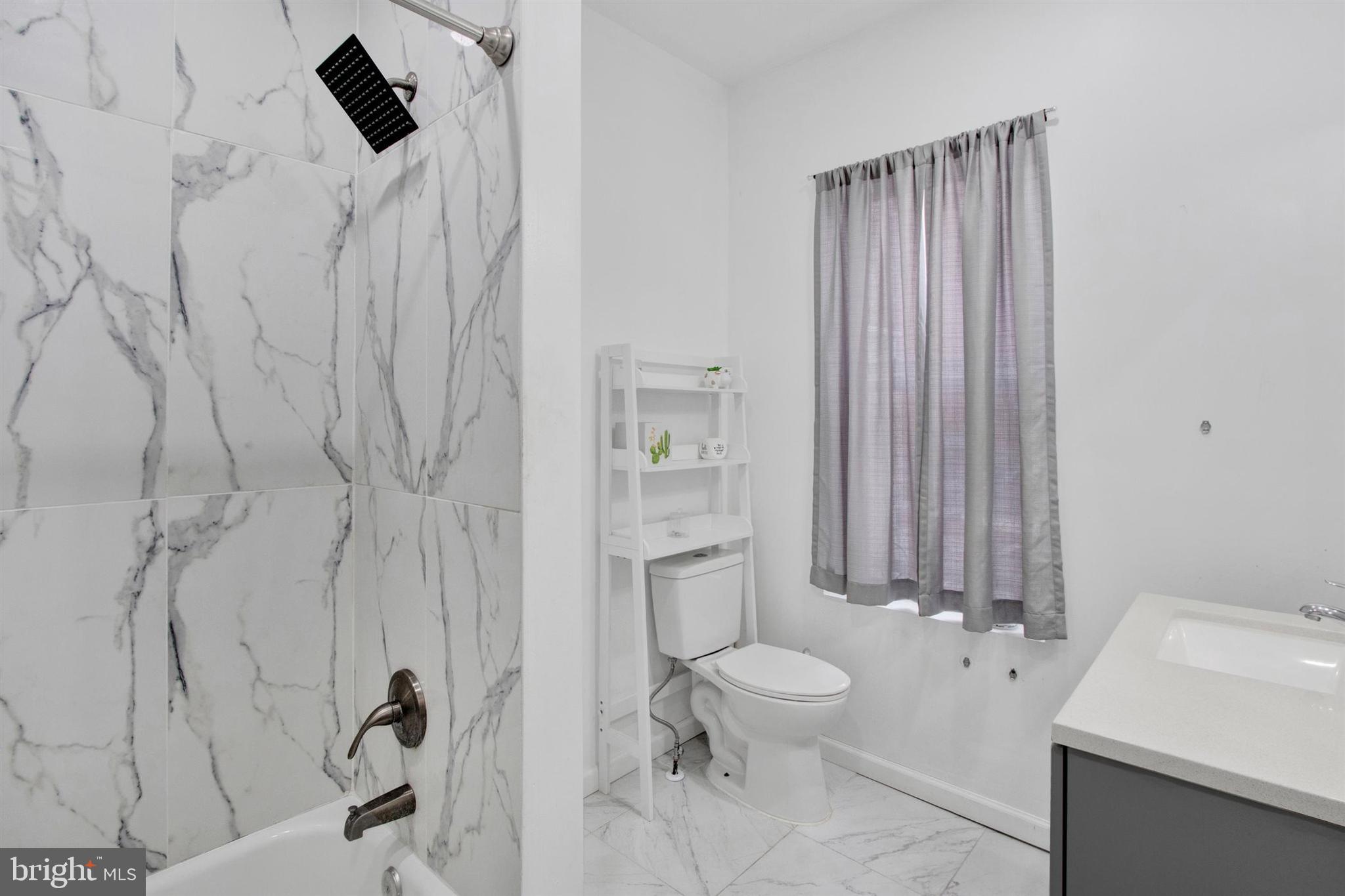 1045 Chestnut Street Reading, PA 19602 - Photo 13 of 21 a bathroom with a toilet sink and shower curtain