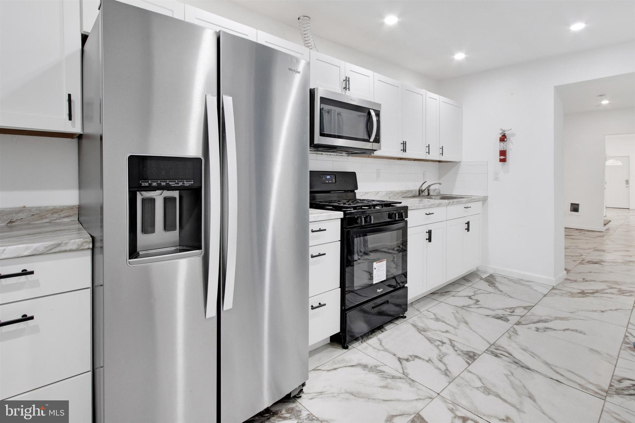 1045 Chestnut Street Reading, PA 19602 - Photo 9 of 21 a kitchen with stainless steel appliances a refrigerator sink and microwave