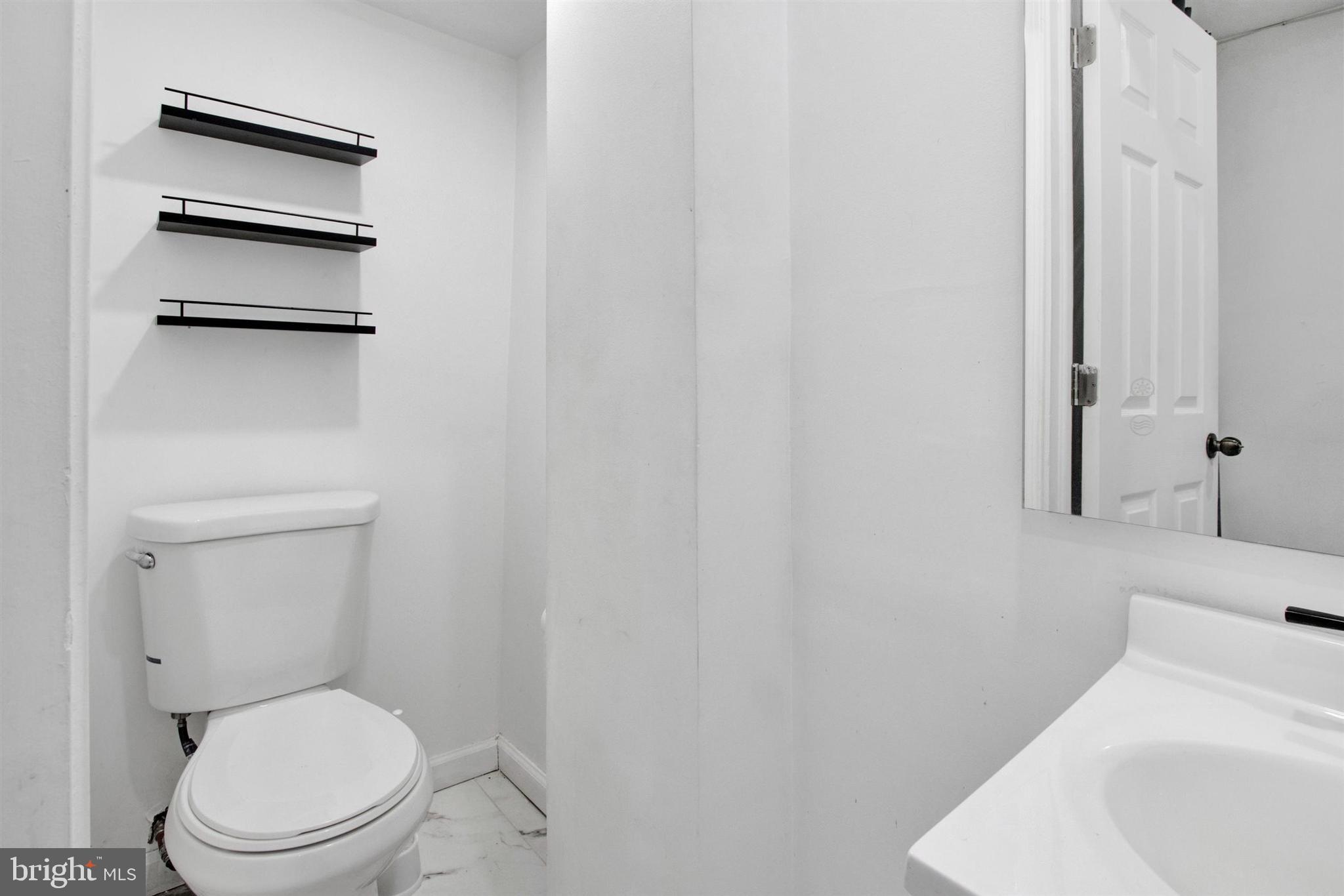 1045 Chestnut Street Reading, PA 19602 - Photo 10 of 21 a white toilet sitting next to a white sink