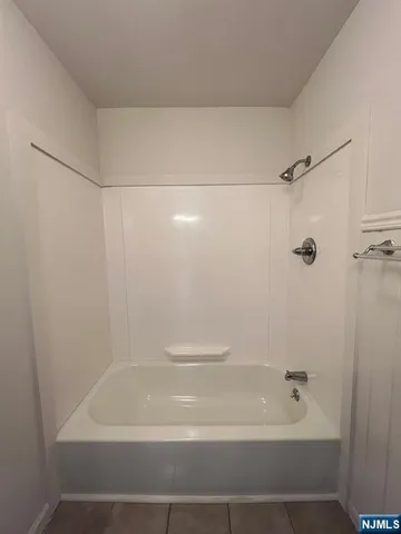 a bathroom with a shower and a bath tub