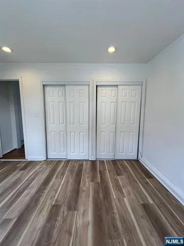 a view of a room with wooden floor and window