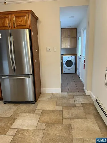 a view of a hallway with a washer and dryer