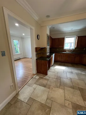 a view of kitchen with windows and refrigerator