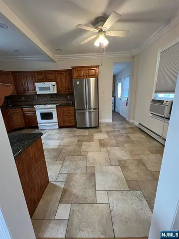 a view of a livingroom with furniture and kitchen view