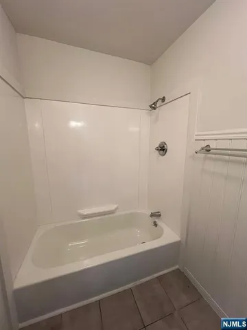 a bathroom with a shower and a bath tub
