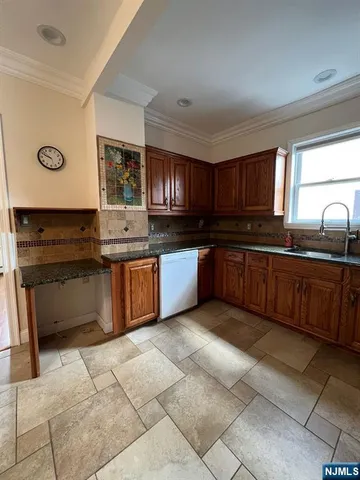 a kitchen with stainless steel appliances granite countertop a stove sink and cabinets
