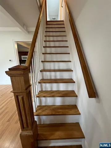 an empty room with wooden floor and entrance