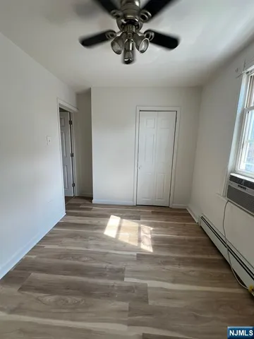 a view of empty room with ceiling fan