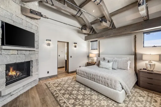 a bedroom with a bed and a fireplace