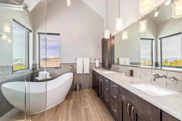 a spacious bathroom with a granite countertop tub sink and mirror