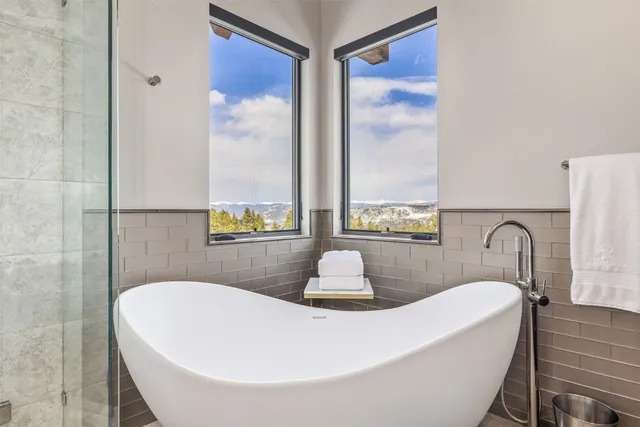 a bath tub sitting in a bathroom next to a window