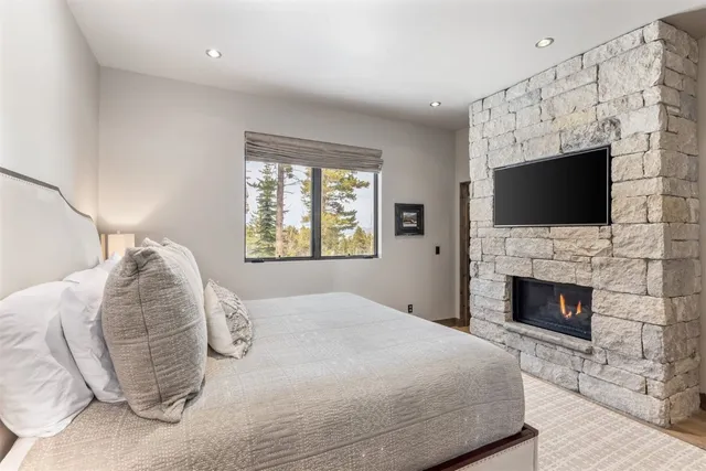 a bedroom with bed and a flat screen tv