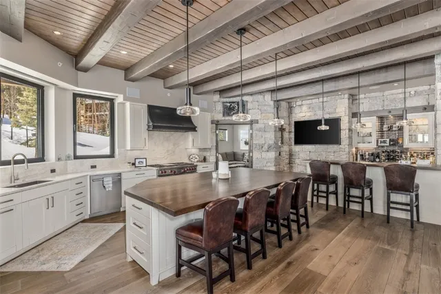 a large kitchen with lots of counter and chairs