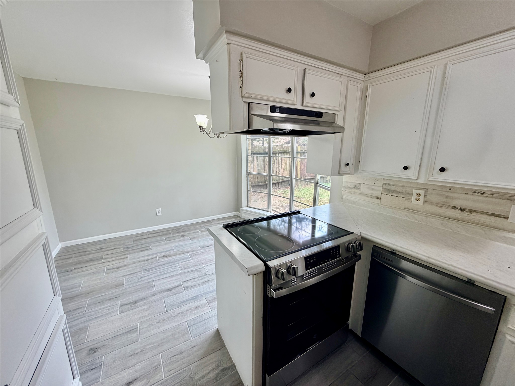 7876 Bender Road Humble, TX 77396 - Photo 11 of 28 a kitchen with kitchen island stainless steel appliances a sink stove and cabinets