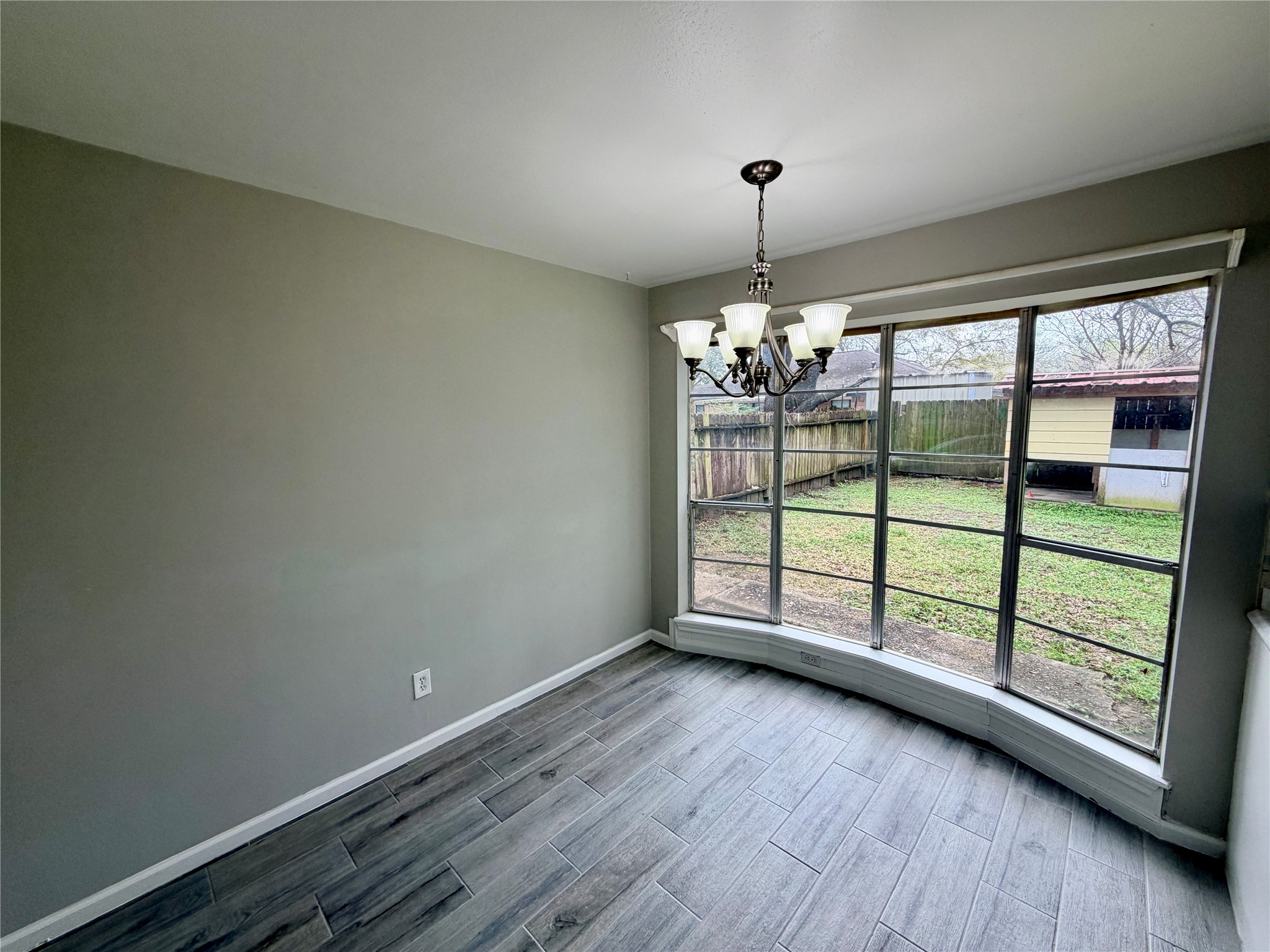 7876 Bender Road Humble, TX 77396 - Photo 14 of 28 wooden floor in an empty room with a window