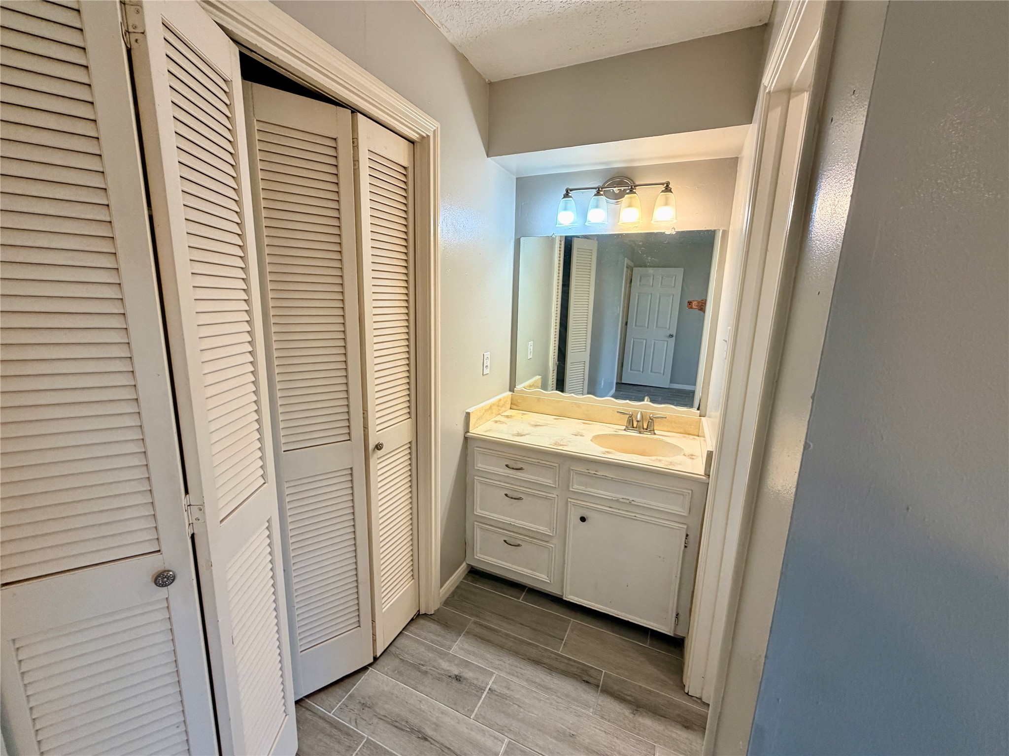 7876 Bender Road Humble, TX 77396 - Photo 17 of 28 a bathroom with a granite countertop sink and a mirror