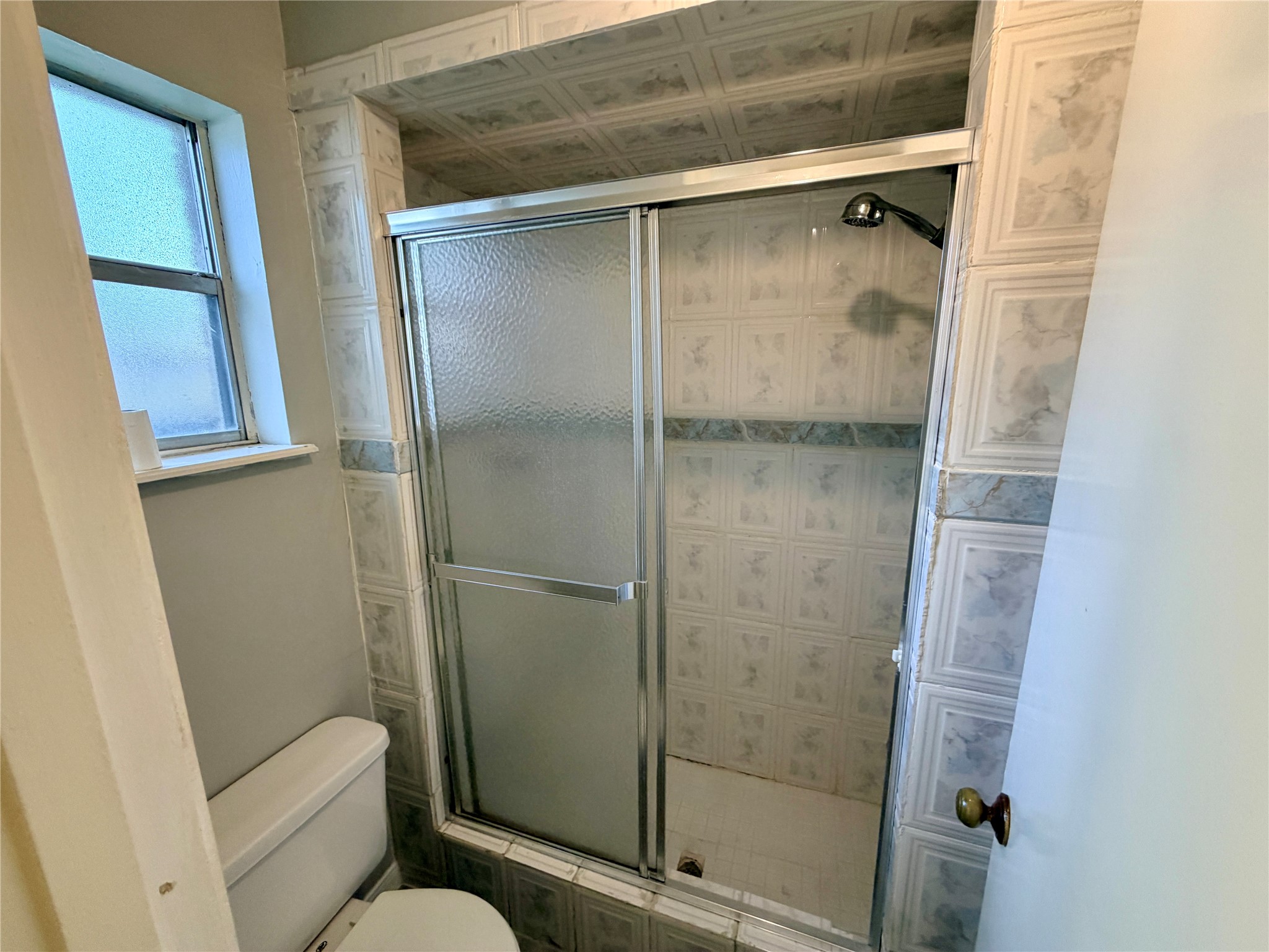 7876 Bender Road Humble, TX 77396 - Photo 18 of 28 a bathroom with a shower and toilet