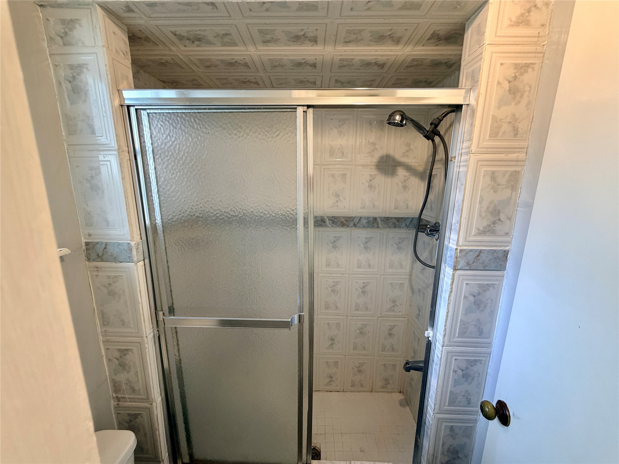 7876 Bender Road Humble, TX 77396 - Photo 19 of 28 a bathroom with a glass shower door