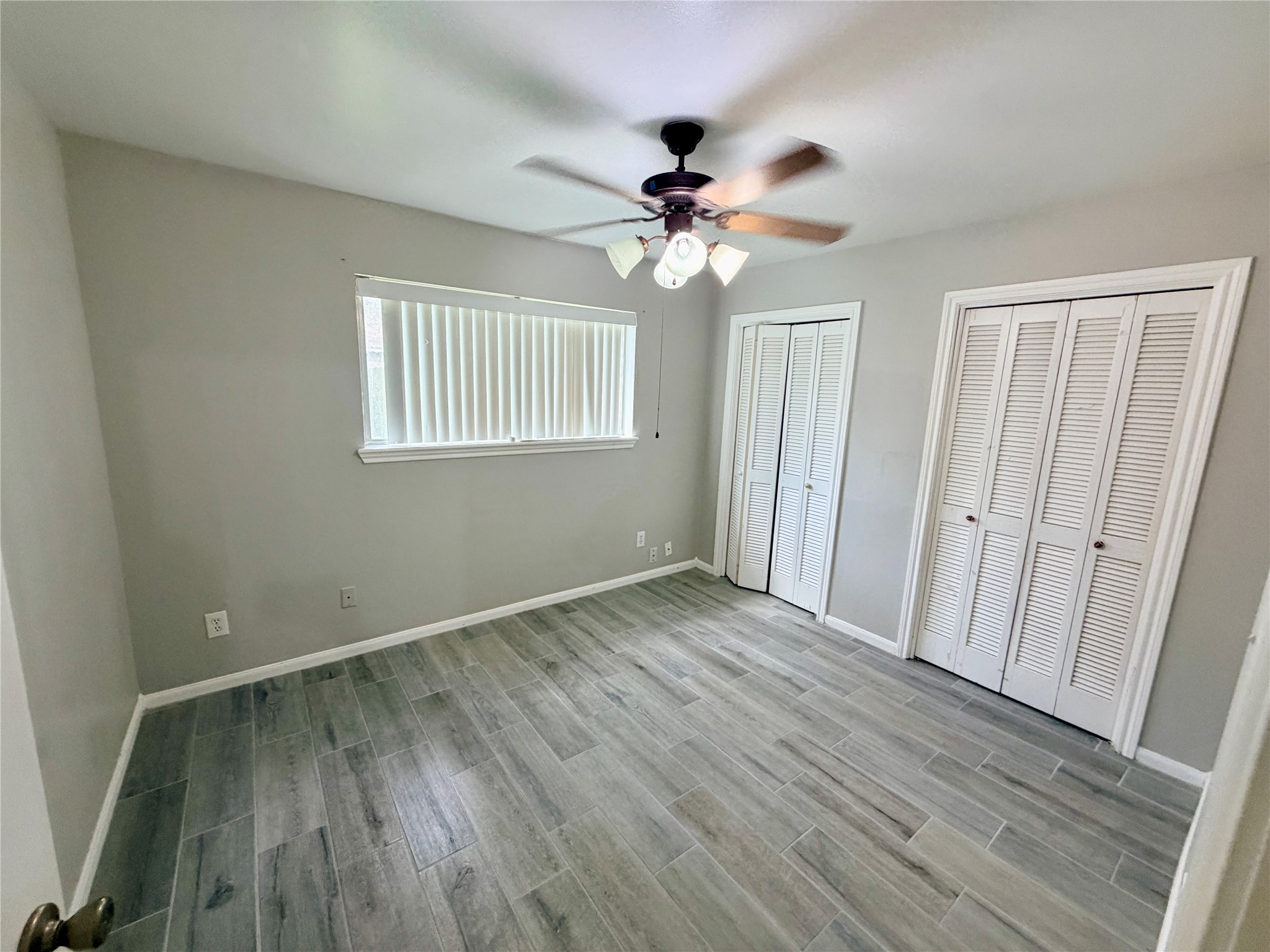 7876 Bender Road Humble, TX 77396 - Photo 20 of 28 a view of empty room with wooden floor and fan