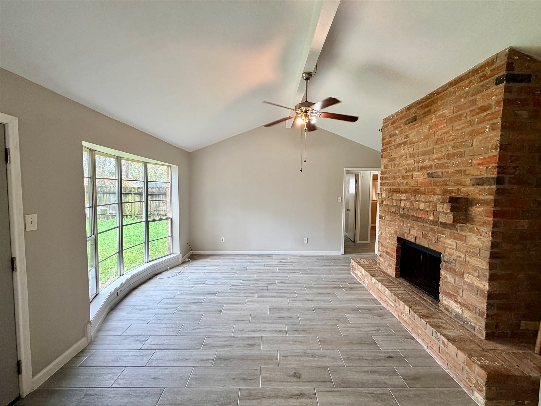 7876 Bender Road Humble, TX 77396 - Photo 3 of 28 a view of an empty room with a fireplace and a window