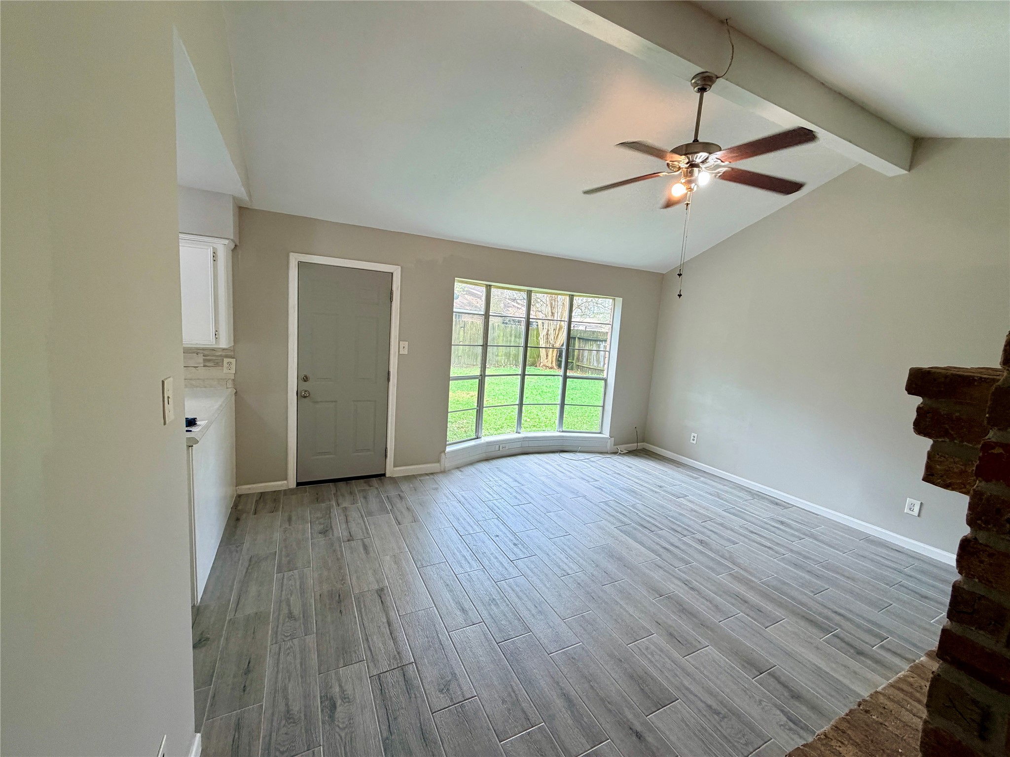 7876 Bender Road Humble, TX 77396 - Photo 5 of 28 an empty room with wooden floor fan and windows