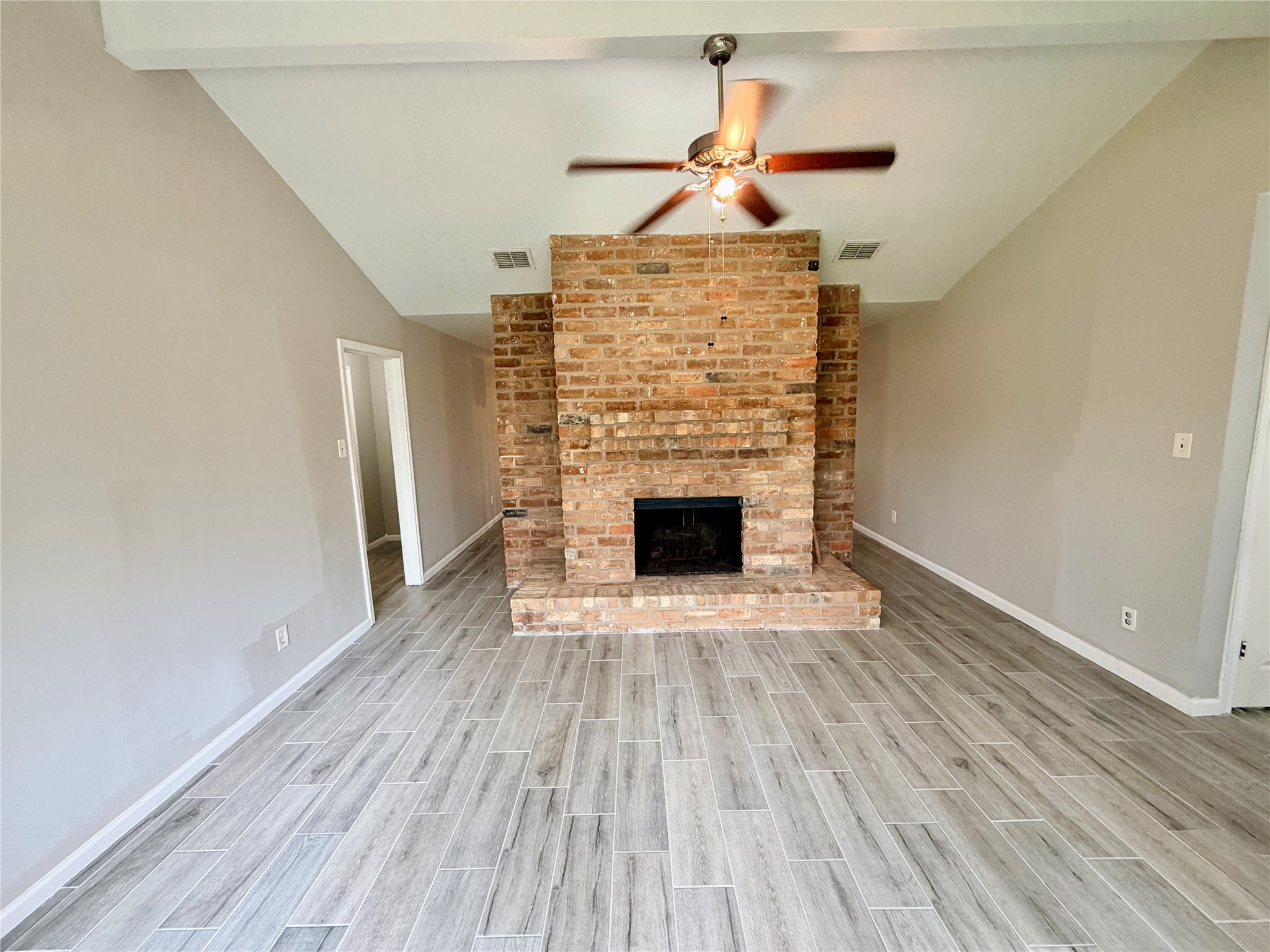 7876 Bender Road Humble, TX 77396 - Photo 6 of 28 a view of empty room with wooden floor and fireplace