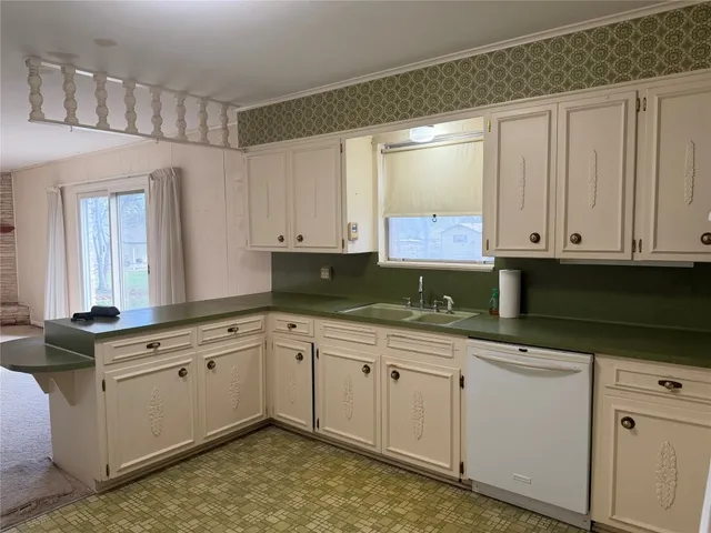 a kitchen with granite countertop white cabinets and white appliances