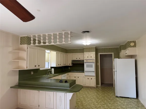 a kitchen with a sink and refrigerator