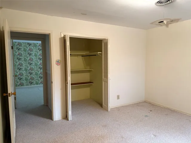 a view of an empty room and closet area