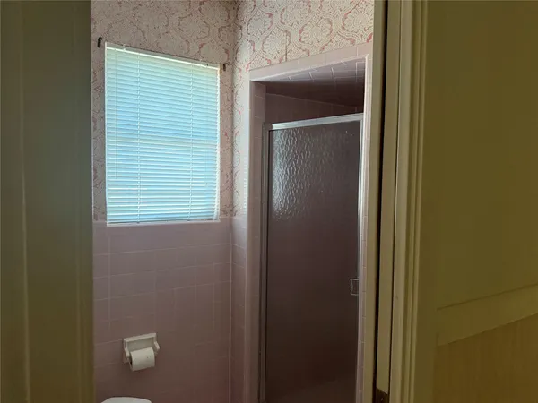 a view of a bathroom that has a window in it