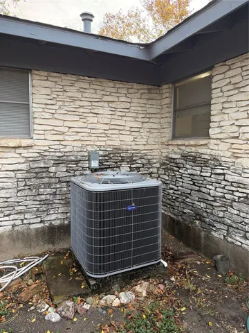 a white house that has a tree in front of it